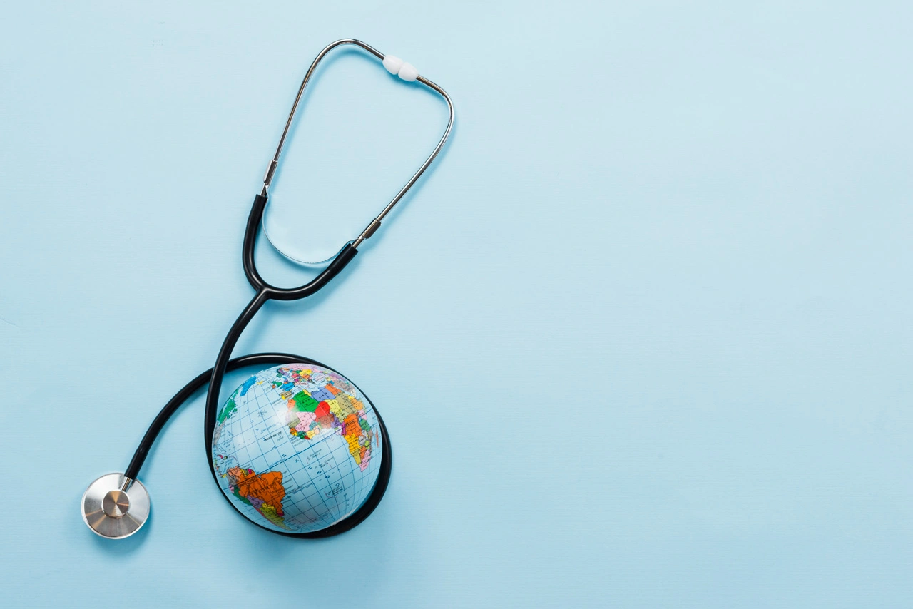 stethoscope-hugging-earth-blue-background stethoscope-hugging-earth-blue-background